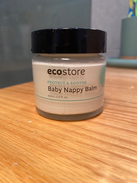 A jar of ecostore Baby Nappy Balm with a black lid, featuring the label 'Protect & Soothe' and indicating a volume of 60ml.